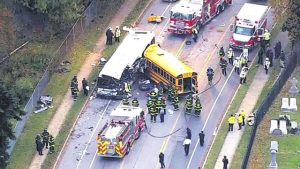 In this frame from video, emergency personnel work at the scene of a fatal school bus and a commuter bus crash in Baltimore yesterday