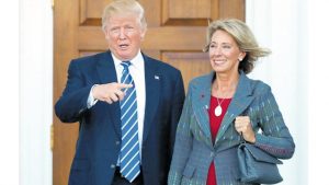 In this November 19, 2016 file photo, President-elect Donald Trump and Betsy DeVos pose for photographs at Trump National Golf Club Bedminster clubhouse in Bedminster, NJ. Trump has chosen charter school advocate DeVos as education secretary in his Administration.