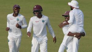 West Indies' cricketer Darren Bravo (2R) holds teammate Devendra Bishoo (R) as they celebrate after the dismissal of Pakistani cricket captain Misbah-ul-Haq unseen the third day of the third and final Test between Pakistan and the West Indies at the Sharjah Cricket Stadium in Sharjah on November 1, 2016. 