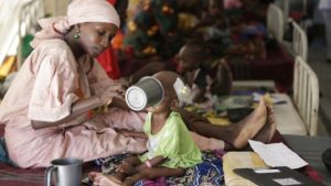 In this Monday, August 29, 2016, photo, a mother feeds her malnourished child at a feeding centre run by Doctors Without Borders in Maiduguri, Nigeria