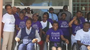 Hon. Konris Maynard (fifth from the left) is blind folded after walking with members of the SKNAPD and supporters in photo on the steps of Government Headquarters